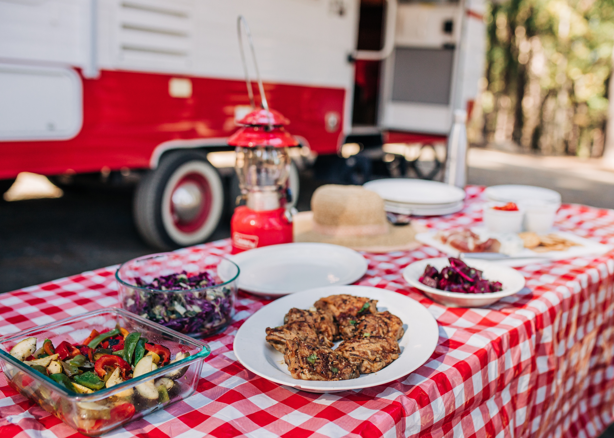 American food on an outdoor table by an RV