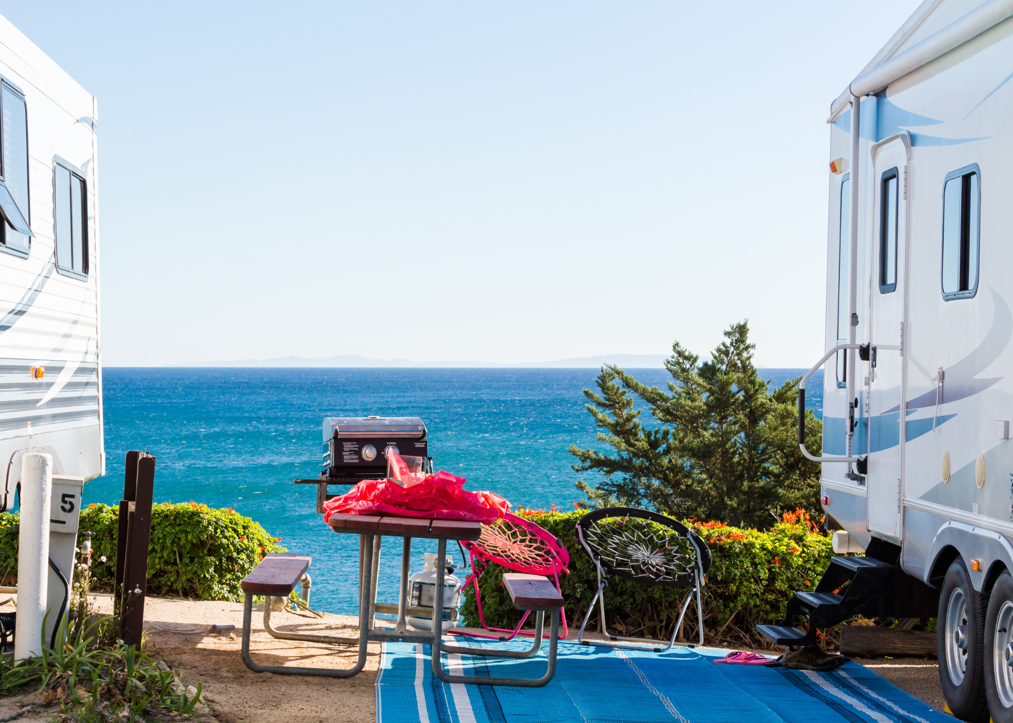 The beach view between two RV vehicles